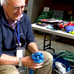 Ruedi Pletscher's passion for knot-tying is evident in his joyful expression, as he expertly weaves together the intricate strands of his latest creation.