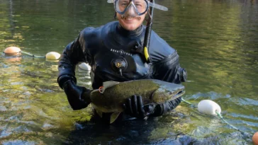 Zach Kapelan holds a chinook salmon.