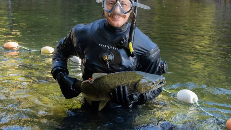 Zach Kapelan holds a chinook salmon.