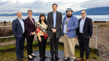 From left to right: Nathan Cullen, Minister of Water, Land and Resource Stewardship; Jennifer Rice, Parliamentary Secretary for Rural Health; K̓áwáziɫ Marilyn Slett, Chief Councillor of the Heiltsuk Nation and President of Coastal First Nations; Premier David Eby; Dallas Smith, President of Nanwakolas Council; and Eddy Adra, CEO of Coast Funds at the funding announcement in Vancouver.