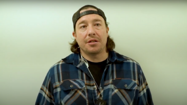 A picture of Jarred Sparrow in a plaid shirt and a cap.