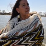 A woman wearing Coast Salish blankets.