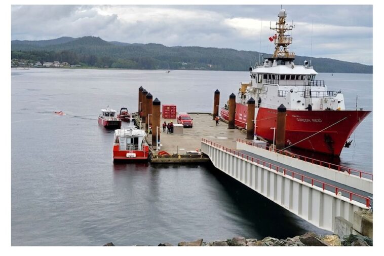 A red Canadian Coast Guard vessel reloading at a dock